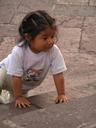 Little girl climbing church steps.